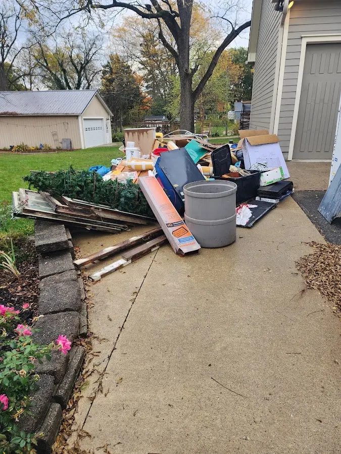 Dumpster being loaded with debris for Estate Cleanout Dumpster Rental in Rumson
